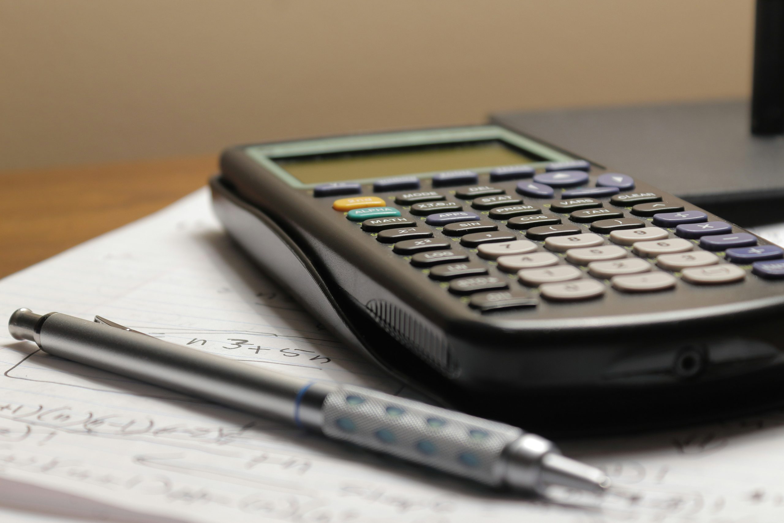Calculator and Pen on Paper - Photo by Aaron Lefler on Unsplash