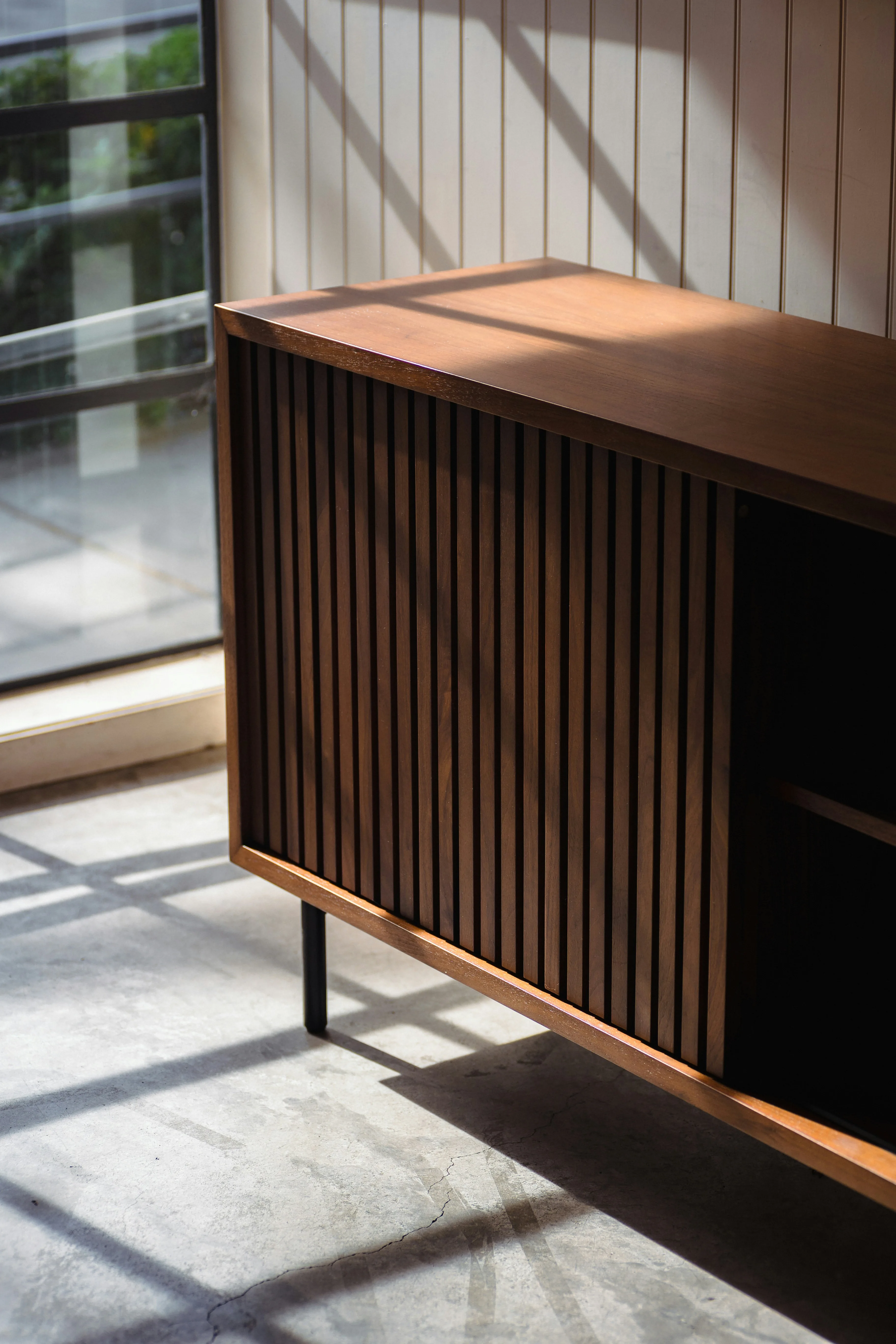 Wooden Cabinet Interior Design - Photo by <a href="https://unsplash.com/@ninjason?utm_content=creditCopyText&utm_medium=referral&utm_source=unsplash">Jason Leung</a> on <a href="https://unsplash.com/photos/a-wooden-cabinet-sitting-in-a-room-next-to-a-window-R2t6RHjCYFM?utm_content=creditCopyText&utm_medium=referral&utm_source=unsplash">Unsplash</a>
